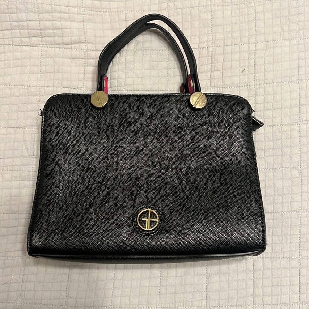 Black with hot pink straps Gianni Bini purse. Polka Dot inner lining.